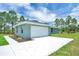 Stylish home showcasing a spacious two-car garage and fresh exterior paint at 3120 Oleander Dr, Indian Lake Estates, FL 33855