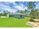 Charming single-story home with a well-maintained lawn and an attached garage at 3120 Oleander Dr, Indian Lake Estates, FL 33855