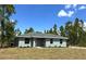 Charming single-story home with a well-manicured lawn and a classic design at 3120 Oleander Dr, Indian Lake Estates, FL 33855