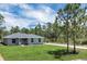 Charming single-story home with a well-manicured lawn and inviting entrance at 3120 Oleander Dr, Indian Lake Estates, FL 33855