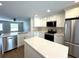 Bright kitchen with stainless steel appliances, central island, and white cabinetry at 3120 Oleander Dr, Indian Lake Estates, FL 33855