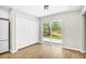 Living area with sliding glass doors leading to yard and closets with bifold doors at 3120 Oleander Dr, Indian Lake Estates, FL 33855