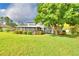 A spacious screened in porch looks out onto a large back yard with a large tree at 329 Hamilton Shores Ne Dr, Winter Haven, FL 33881
