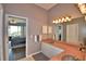 Bright bathroom offers a double sink vanity and a view into the main bedroom at 329 Hamilton Shores Ne Dr, Winter Haven, FL 33881
