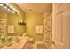 Bathroom featuring a shower-tub combination with decorative curtains, complemented by a vanity and a neutral color palette at 329 Hamilton Shores Ne Dr, Winter Haven, FL 33881