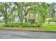 Beautiful Hamilton Pointe community entrance with brick signage, lush landscaping, and mature trees draped with Spanish moss at 329 Hamilton Shores Ne Dr, Winter Haven, FL 33881