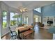 The dining area offers beautiful views through the large windows and access to the living room at 329 Hamilton Shores Ne Dr, Winter Haven, FL 33881