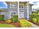 Charming two-story home with manicured landscaping and a welcoming entrance, offering an inviting facade at 329 Hamilton Shores Ne Dr, Winter Haven, FL 33881