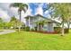 A lush front yard and mature trees complement this two-story home, enhancing its curb appeal at 329 Hamilton Shores Ne Dr, Winter Haven, FL 33881