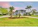 Stunning two-story home featuring a circular driveway and meticulously maintained landscaping at 329 Hamilton Shores Ne Dr, Winter Haven, FL 33881
