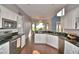 Bright kitchen with stainless steel appliances, white cabinets and a view into the dining area at 329 Hamilton Shores Ne Dr, Winter Haven, FL 33881