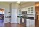 Well-lit kitchen features stainless steel appliances, white cabinets, and stylish dark countertops at 329 Hamilton Shores Ne Dr, Winter Haven, FL 33881