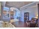 Inviting living room featuring a coffered ceiling, elegant columns, and decorative lighting at 329 Hamilton Shores Ne Dr, Winter Haven, FL 33881