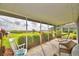 A delightful screened-in patio offers a serene outdoor retreat with comfortable seating and picturesque landscape views at 329 Hamilton Shores Ne Dr, Winter Haven, FL 33881