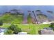Aerial view showing multiple docks on a waterfront property, with lush green vegetation at 329 Hamilton Shores Ne Dr, Winter Haven, FL 33881