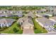 Aerial view of the home showcasing the well-manicured lawn, landscaping, and paver driveway at 3710 Plymouth Dr, Winter Haven, FL 33884