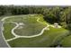 Aerial view of the community park with walking paths, dog park, picnic areas, and lush greenery at 3710 Plymouth Dr, Winter Haven, FL 33884