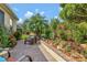 Beautiful backyard garden with brick patio, mature landscaping, and plenty of seating areas at 3710 Plymouth Dr, Winter Haven, FL 33884