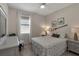 Cozy bedroom with neutral walls, tile floor, window with blinds, and nautical decor at 3710 Plymouth Dr, Winter Haven, FL 33884