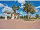 Traditional community gatehouse with a welcoming entrance, beautiful landscaping, and a view of the neighborhood at 3710 Plymouth Dr, Winter Haven, FL 33884