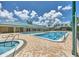 A large community pool with a hot tub, surrounded by palm trees and a spacious pool deck for relaxing at 3710 Plymouth Dr, Winter Haven, FL 33884