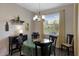 Dining room with a glass table and black chairs situated by a window with natural light at 3710 Plymouth Dr, Winter Haven, FL 33884