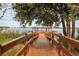 Picturesque wooden dock leading to a gazebo, offering stunning views of the lake and surrounding natural beauty at 3710 Plymouth Dr, Winter Haven, FL 33884
