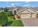 Single-story home with brick driveway, three-car garage, and lush landscaping at 3710 Plymouth Dr, Winter Haven, FL 33884