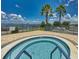 Inviting hot tub overlooking the lake, with views of palm trees and clear skies, perfect for relaxation at 3710 Plymouth Dr, Winter Haven, FL 33884