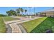 Community recreation area with bocce ball court, pergola covered seating, and manicured landscaping at 3710 Plymouth Dr, Winter Haven, FL 33884