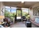 Comfortable screened porch with wicker furniture, ceiling fan, and views of the lush backyard at 3710 Plymouth Dr, Winter Haven, FL 33884