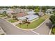 Corner lot home featuring lush landscaping, a brick driveway, and a well-maintained lawn at 3912 Baldwin Ln, Winter Haven, FL 33884