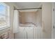 Walk-in tub features safety grab bars, a showerhead, and a glass door for easy and safe access at 3912 Baldwin Ln, Winter Haven, FL 33884