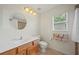 Bathroom with a wood vanity, toilet, framed mirror, and shower-tub combination, offering functionality at 3912 Baldwin Ln, Winter Haven, FL 33884