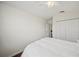Simple bedroom with hardwood floors, closet, ceiling fan, and a comfortable bed at 3912 Baldwin Ln, Winter Haven, FL 33884