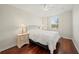 Bright bedroom featuring hardwood floors, a comfortable bed, and a large window for natural light at 3912 Baldwin Ln, Winter Haven, FL 33884