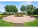 Circular seating area in community, showcasing benches, garden beds, and lush green grass at 3912 Baldwin Ln, Winter Haven, FL 33884
