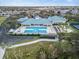 Aerial view of the community pool and amenities, including the clubhouse, tennis courts, and bocce ball at 3912 Baldwin Ln, Winter Haven, FL 33884