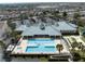 Aerial shot of the community pool area, including the spa, tennis courts, and clubhouse at 3912 Baldwin Ln, Winter Haven, FL 33884