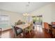 Bright dining area features wood floors, a chandelier, and sliding glass doors to the patio at 3912 Baldwin Ln, Winter Haven, FL 33884