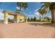 Gated entrance to Traditions community featuring a guard house and meticulously kept landscaping at 3912 Baldwin Ln, Winter Haven, FL 33884