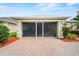 Well-lit screened garage with a brick driveway offering ample space for vehicles and storage at 3912 Baldwin Ln, Winter Haven, FL 33884