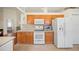 A clean and tidy kitchen with wood cabinetry and modern appliances at 3912 Baldwin Ln, Winter Haven, FL 33884