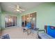Covered outdoor patio featuring tile flooring, a ceiling fan, and comfortable seating with views at 3912 Baldwin Ln, Winter Haven, FL 33884