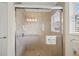 Modern tiled shower with glass enclosure, handheld shower head, and grab bars for added safety and convenience at 3912 Baldwin Ln, Winter Haven, FL 33884