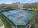 Aerial view of multiple well-maintained tennis courts with lush greenery, and well-kept landscaping at 3912 Baldwin Ln, Winter Haven, FL 33884