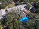 A sprawling property with lush greenery, with a pool and Tiki hut at 4010 Paw Paw Trl, Lake Wales, FL 33898