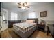 Bedroom with ceiling fan, hardwood floors and a queen sized bed at 4010 Paw Paw Trl, Lake Wales, FL 33898