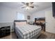 Bedroom with ceiling fan, hardwood floors, a desk and a queen sized bed at 4010 Paw Paw Trl, Lake Wales, FL 33898