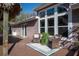 Exterior image of a covered patio area features wicker furniture and a blue rug, offering a cozy outdoor seating space at 4010 Paw Paw Trl, Lake Wales, FL 33898